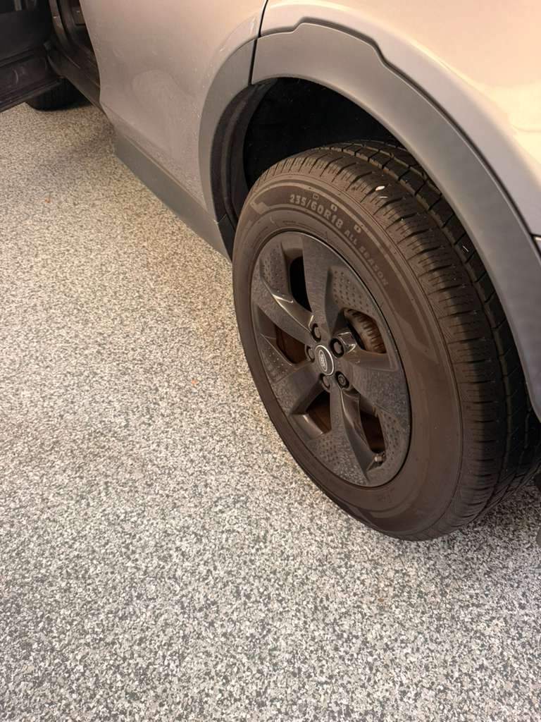 Close-up of alloy wheel and tire tread
